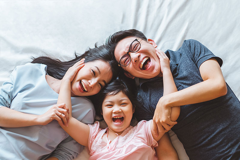 Family Happy and Smiling laying down